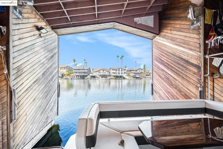Dock area with a water view, a residential view, and a balcony