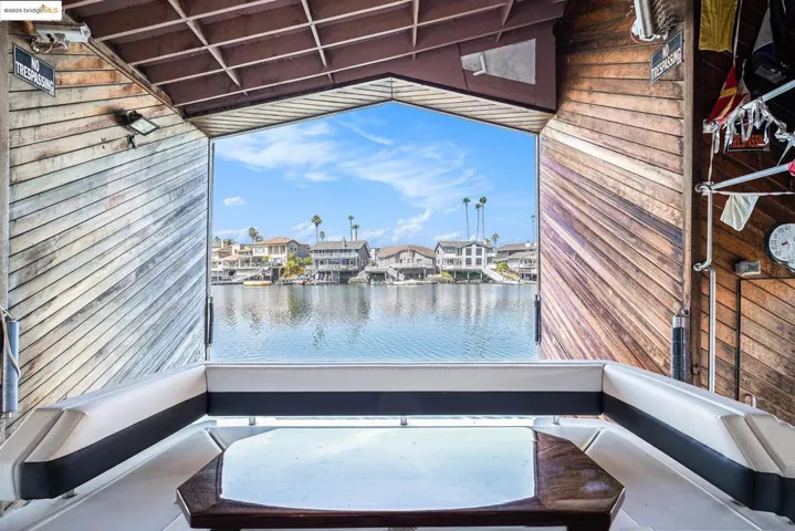 Patio / terrace with a residential view and a water view