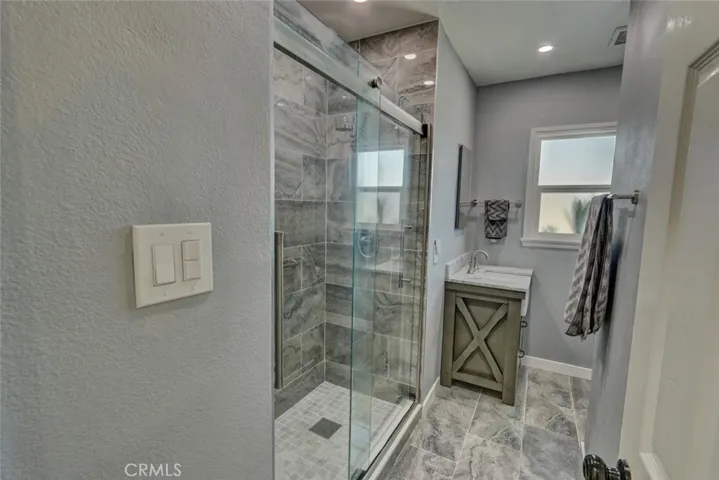 Main bathroom redone in 2023 with tile floor and recessed lights.