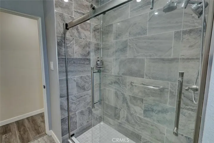 Spacious walk in shower with sliding glass doors