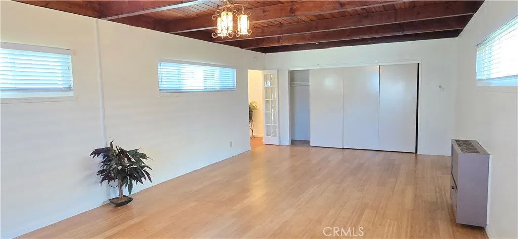Wood beam ceiling. Long wall of closets