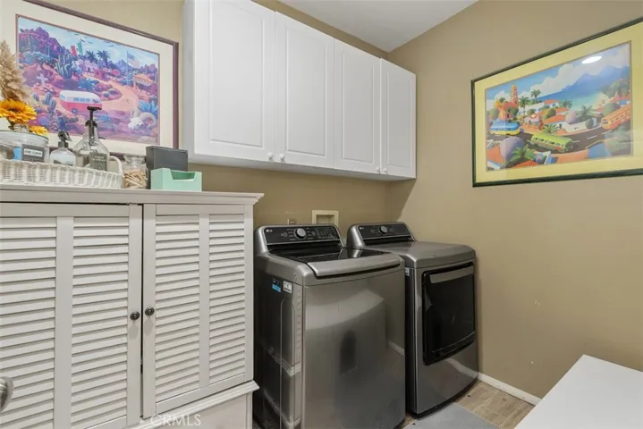 Laundry room featuring upper white cabinetry.