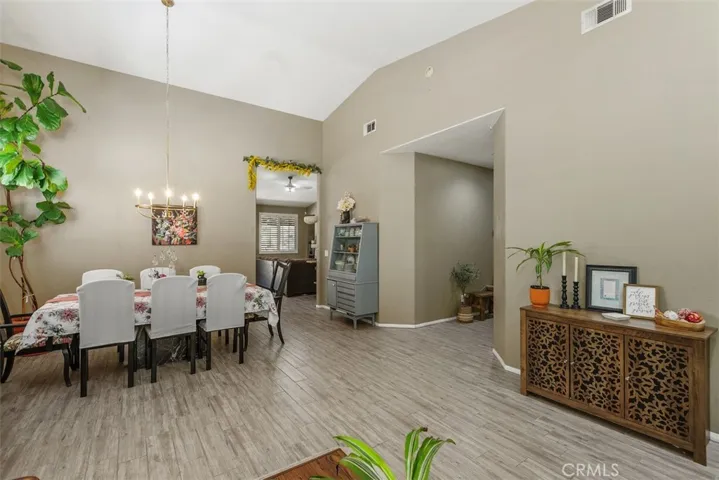 Dining Room and Hallway Leading to Bedrooms, Kitchen, and Family Room.