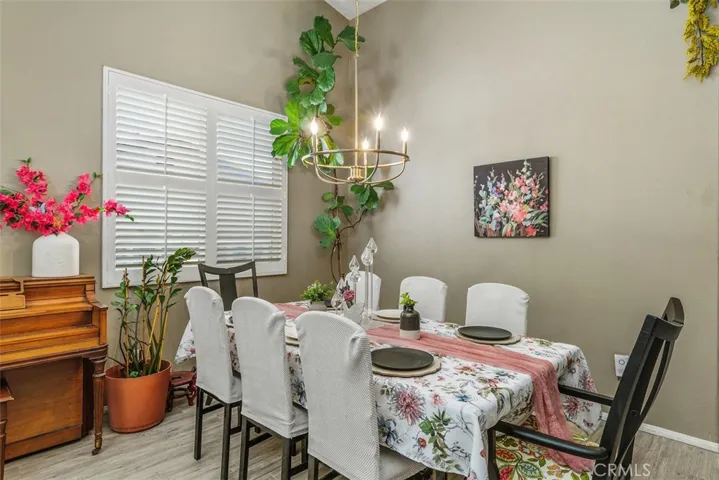 Formal Dining room with shutters and stylish gold light fixture.