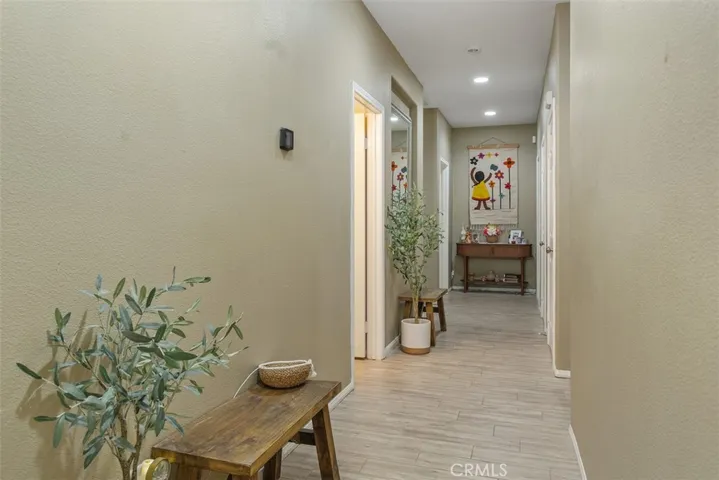 View of the hallway leading to the bedrooms, secondary bathroom, and laundry room.