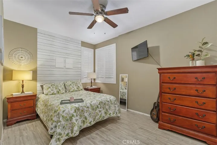 Bedroom 4 includes a ceiling fan, tiled floors, and shutters.