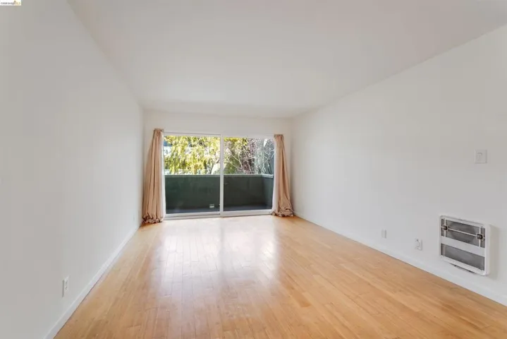 Spare room with heating unit and light wood finished floors