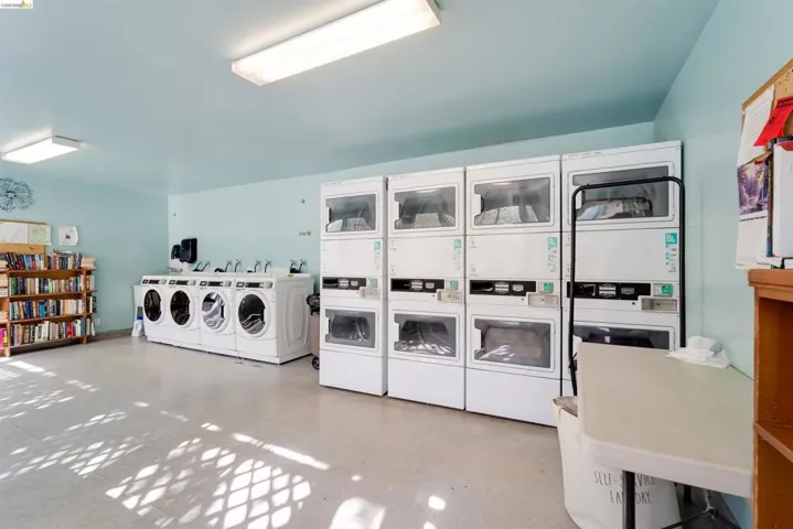 Shared laundry room featuring washing machine and clothes dryer and stacked washing machine and dryer