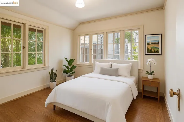 Bedroom featuring vaulted ceiling and wood finished floors