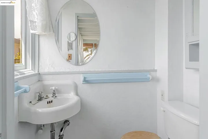 Half bath featuring toilet and a textured wall