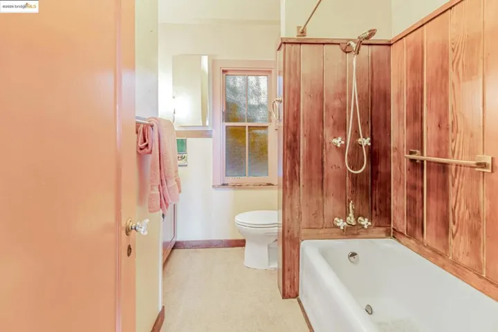Full bathroom featuring toilet and baseboards
