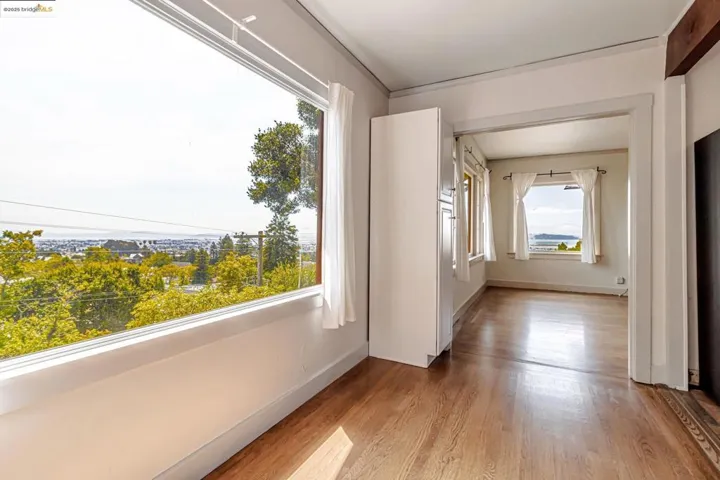 Spare room with light wood-style floors and baseboards