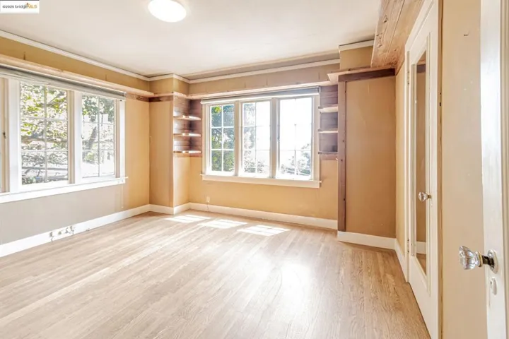 Unfurnished bedroom featuring light wood-style flooring and ornamental molding