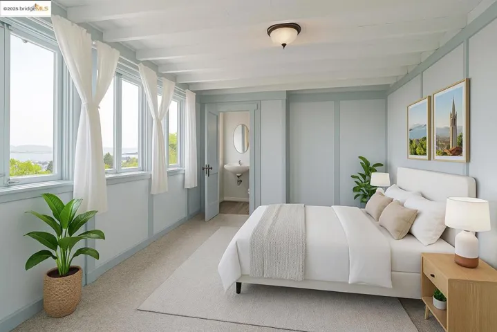 Carpeted bedroom with beam ceiling and a mountain view