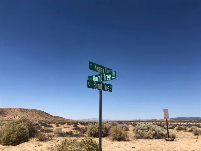 You can turn here and go west to American Way then  go north to the lot.