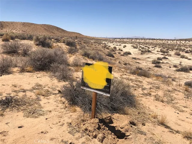 Sign is on the eastern boundary at the elbow of Mountain View and Burnt Tree. The hill in the background is adjacent to your lot for the western boundary line.