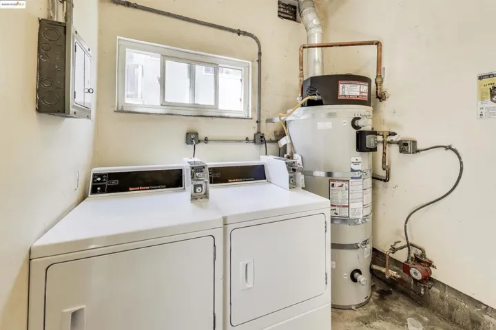 Community laundry featuring water heater and independent washer and dryer