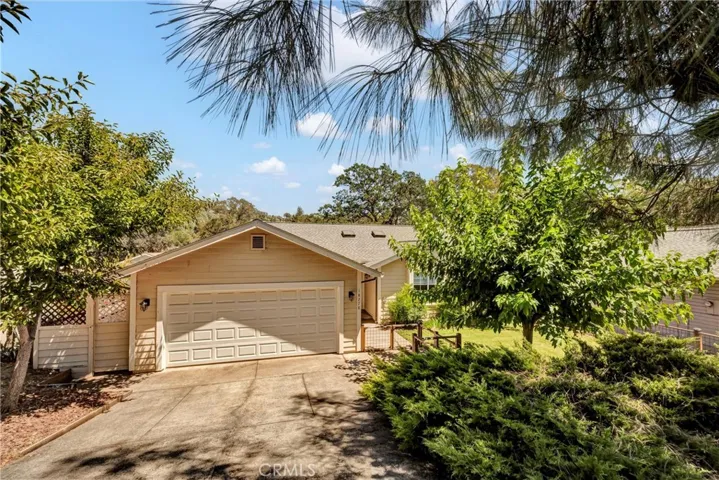 Downsloping driveway leads to a lovely front yard