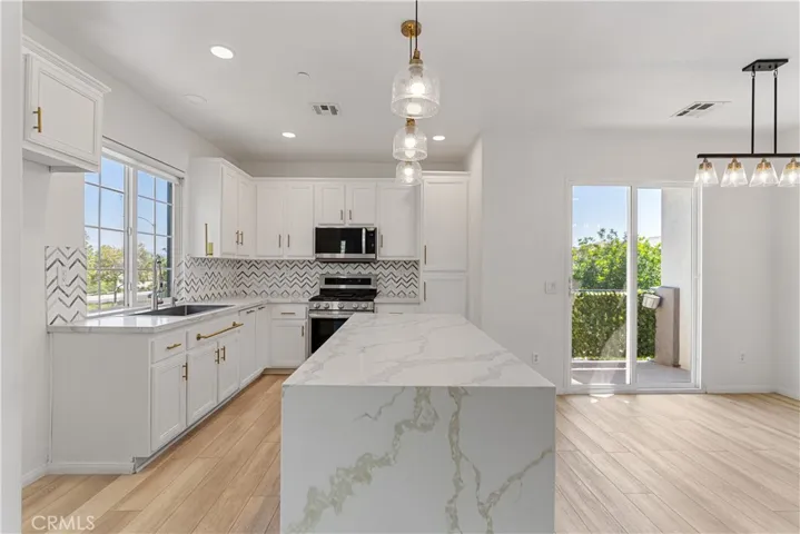 Beautiful kitchen with waterfall countertop on island!