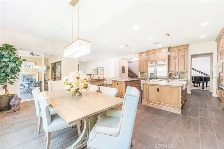 The oversized breakfast area, versatile enough to serve as a formal dining space, opens directly to the kitchen, living room and backyard creating a bright and inviting spot for meals and gatherings.