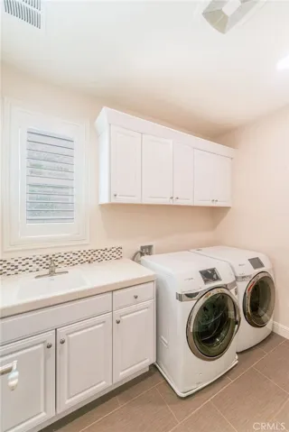 The laundry room is equipped with a convenient sink, making laundry and household tasks easier and more efficient.