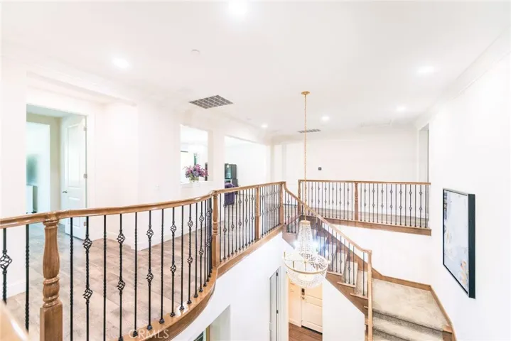 Elegant wood and wrought-iron railing overlooks the foyer below