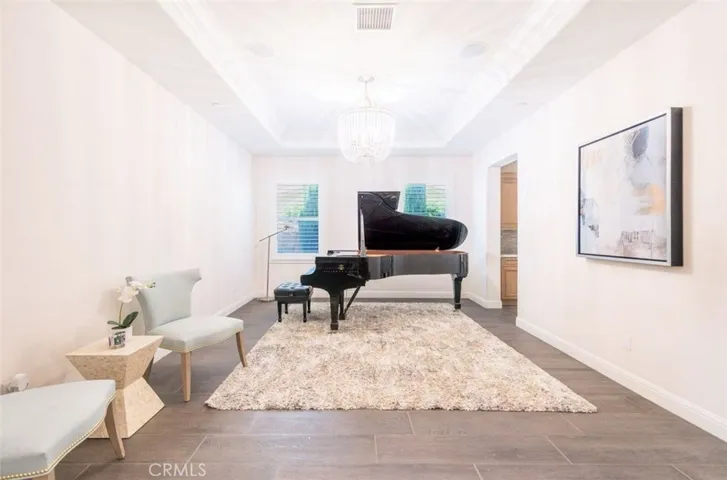 Separate formal dining with tray ceiling and large windows can also be used as flex area.