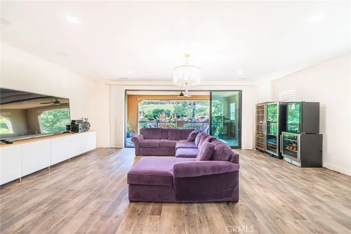 The spacious game room features a sliding door that opens completely to the balcony, seamlessly extending the living space and offering a bright, airy area for fun and relaxation.