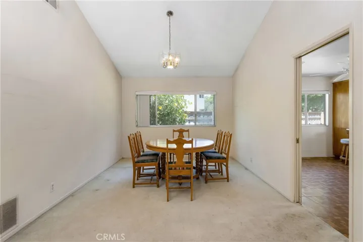 Living room and dining room have a grand feel with vaulted ceilings, fireplace, and tons of natural light.