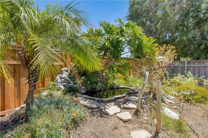 With over 9,000SF of lot, the backyard is well manicured with vegetable beds, fruit bearing trees, mature bushes, built-in fire pit and so much more! Pool sized lot!!