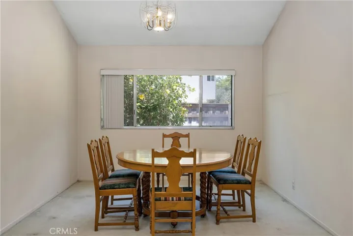 Living room and dining room have a grand feel with vaulted ceilings, fireplace, and tons of natural light.