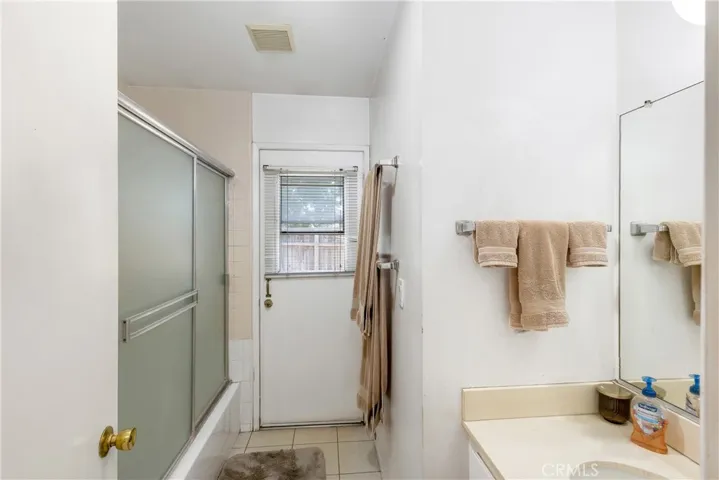 Second bathroom is spacious and has access to the backyard.