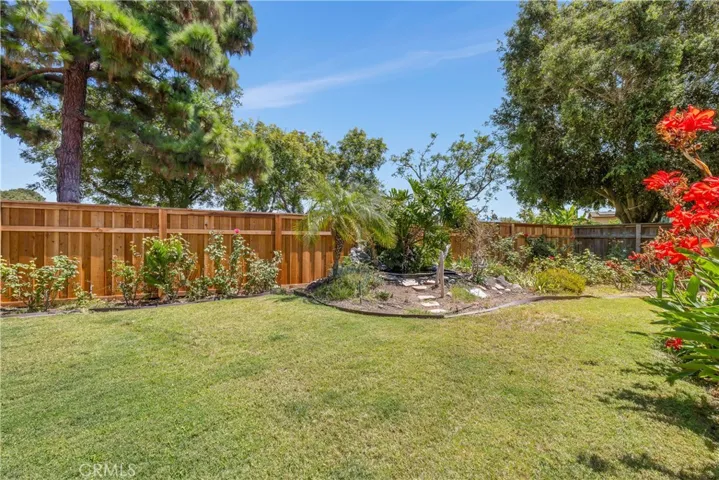 With over 9,000SF of lot, the backyard is well manicured with vegetable beds, fruit bearing trees, mature bushes, built-in fire pit and so much more! Pool sized lot!!