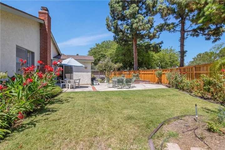 With over 9,000SF of lot, the backyard is well manicured with vegetable beds, fruit bearing trees, mature bushes, built-in fire pit and so much more! Pool sized lot!!