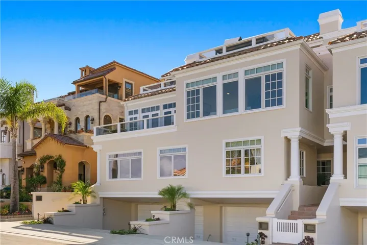 Generous driveway space and a finished 3-car garage provide rare parking convenience in this beachside location.