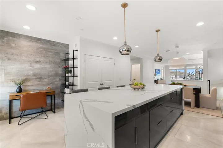 The open-concept kitchen flows seamlessly into the dining and living spaces for effortless entertainment