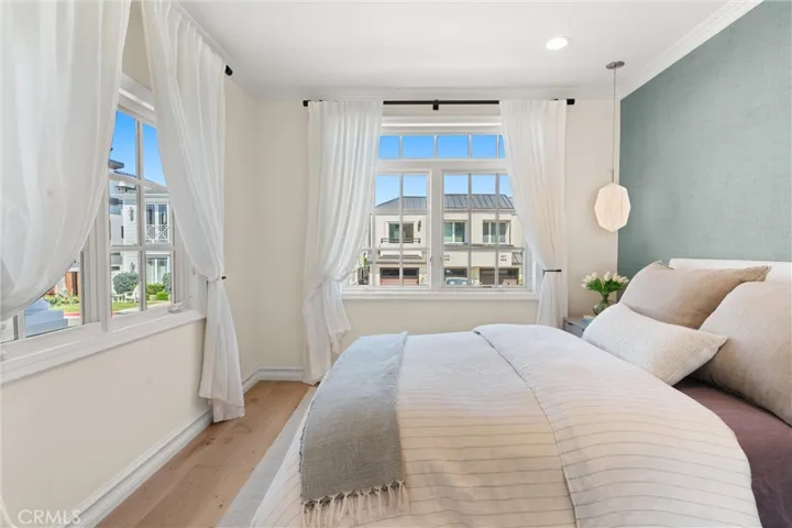 Bright and airy ground floor guest room featuring picture windows with charming neighborhood views.