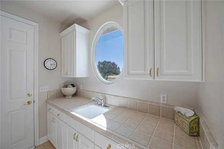 Sink in Laundry Room with door leading into one of the garage areas