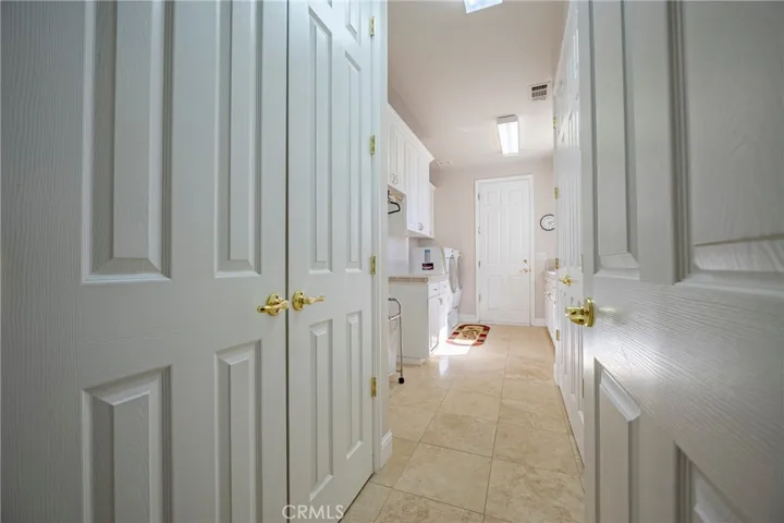 Lots of storage leading into spacious laundry room