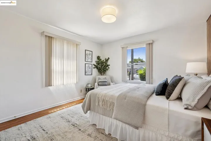 Bedroom with wood finished floors and baseboards