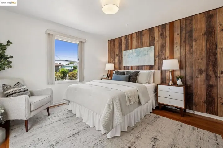 Bedroom with wooden walls and wood finished floors