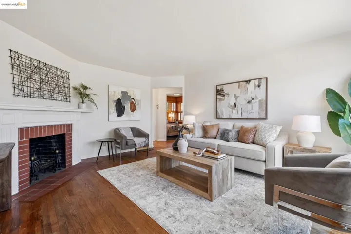 Living room featuring dark wood-style flooring and a fireplace