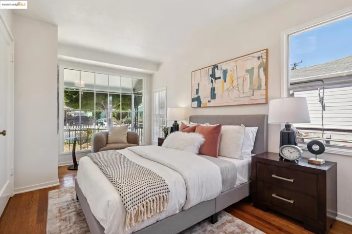 Bedroom featuring wood finished floors and baseboards