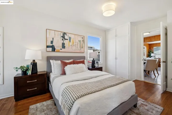 Bedroom featuring dark wood-type flooring and a closet