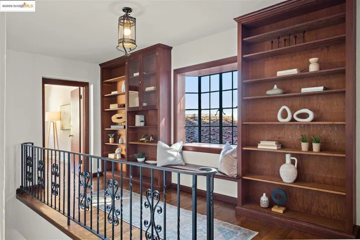 Office with dark wood-style flooring and baseboards