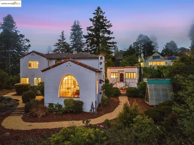 Property exterior at dusk with a tile roof and stucco siding