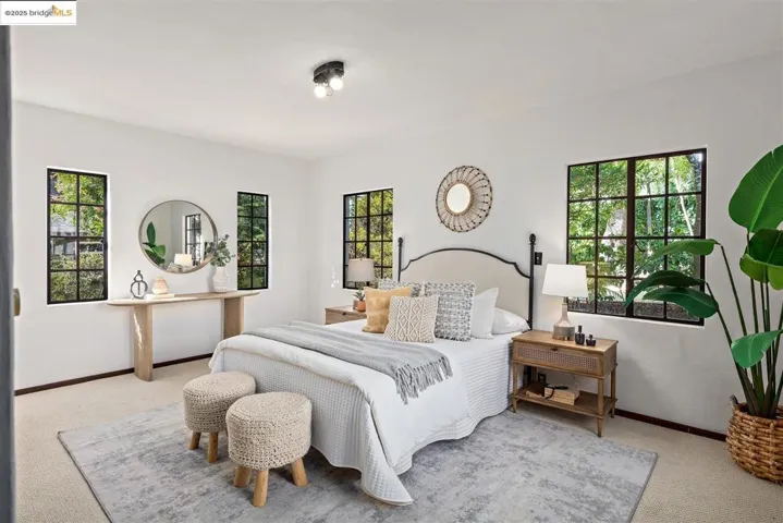 Bedroom with carpet and multiple windows