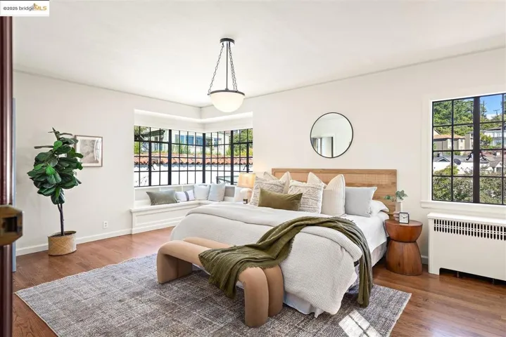 Bedroom featuring radiator heating unit and dark wood-style floors