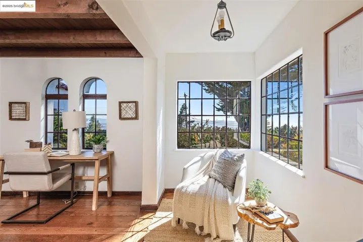 Living area with wood finished floors and a wooden ceiling with exposed beams