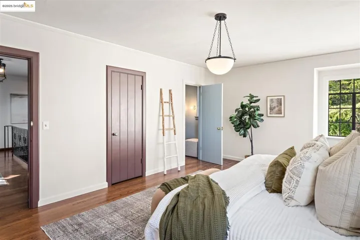 Bedroom featuring wood finished floors, a closet, and crown molding